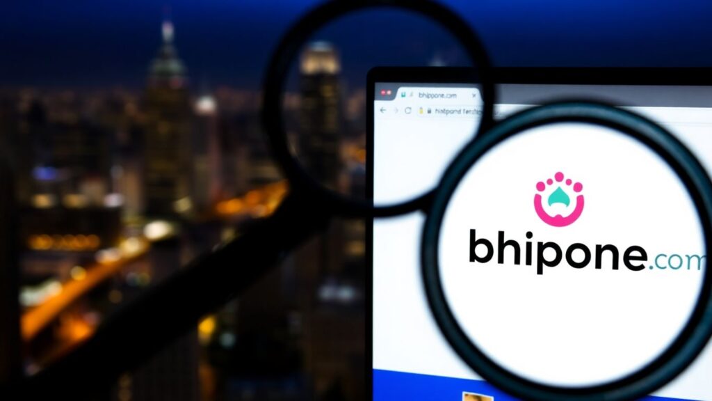 Magnifying glass over Bhipone.com logo, investigating legitimacy.
